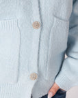 close up of buttons on lyla & luxe stella crystal button cardigan