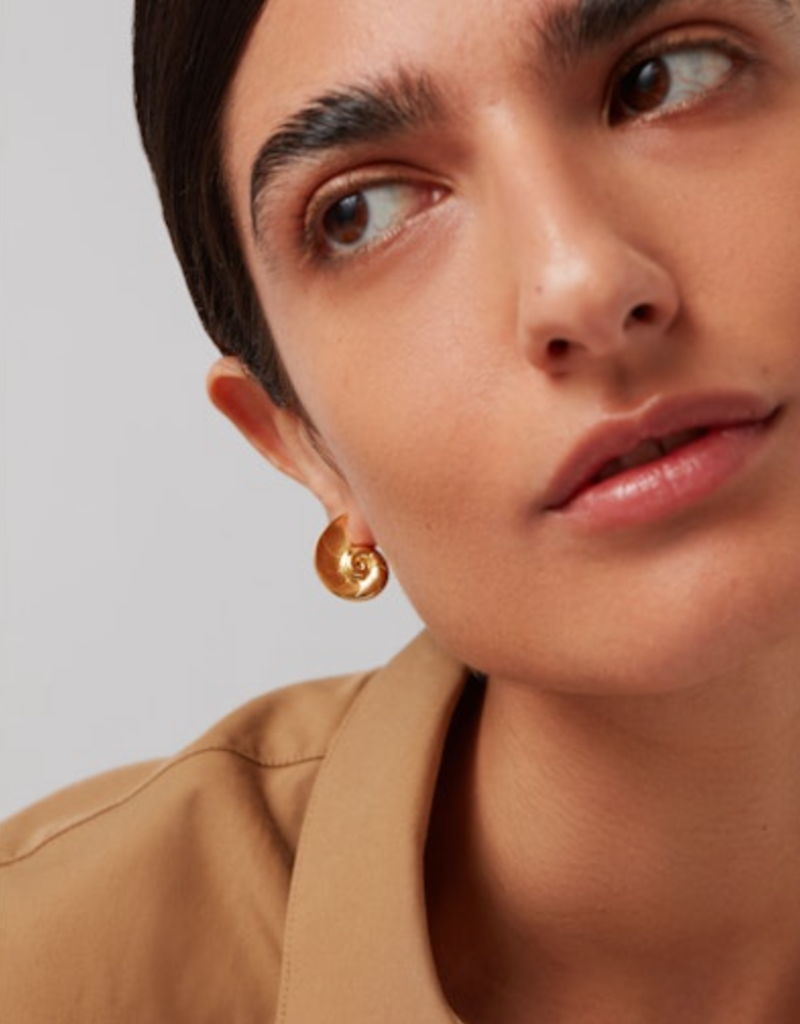 model wearing the jenny bird nautilus shaped dylan earrings in gold