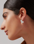 model wearing jenny bird nautilus shaped dylan earrings in gold