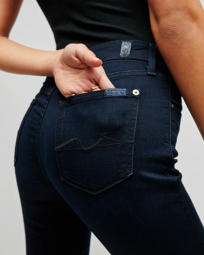 Close up of the back stitching on 7 for all mankind's kimmie mid rise straight leg jeans in dark blue denim