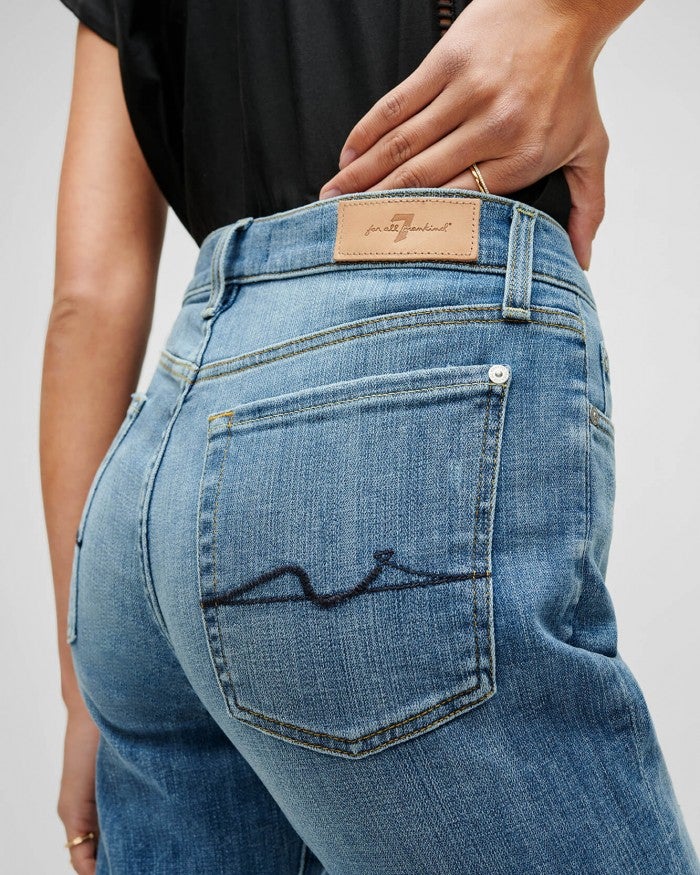close up of stitching on the rear pocket of the 7 for all mankind josefina boyfriend jeans in a light blue wash